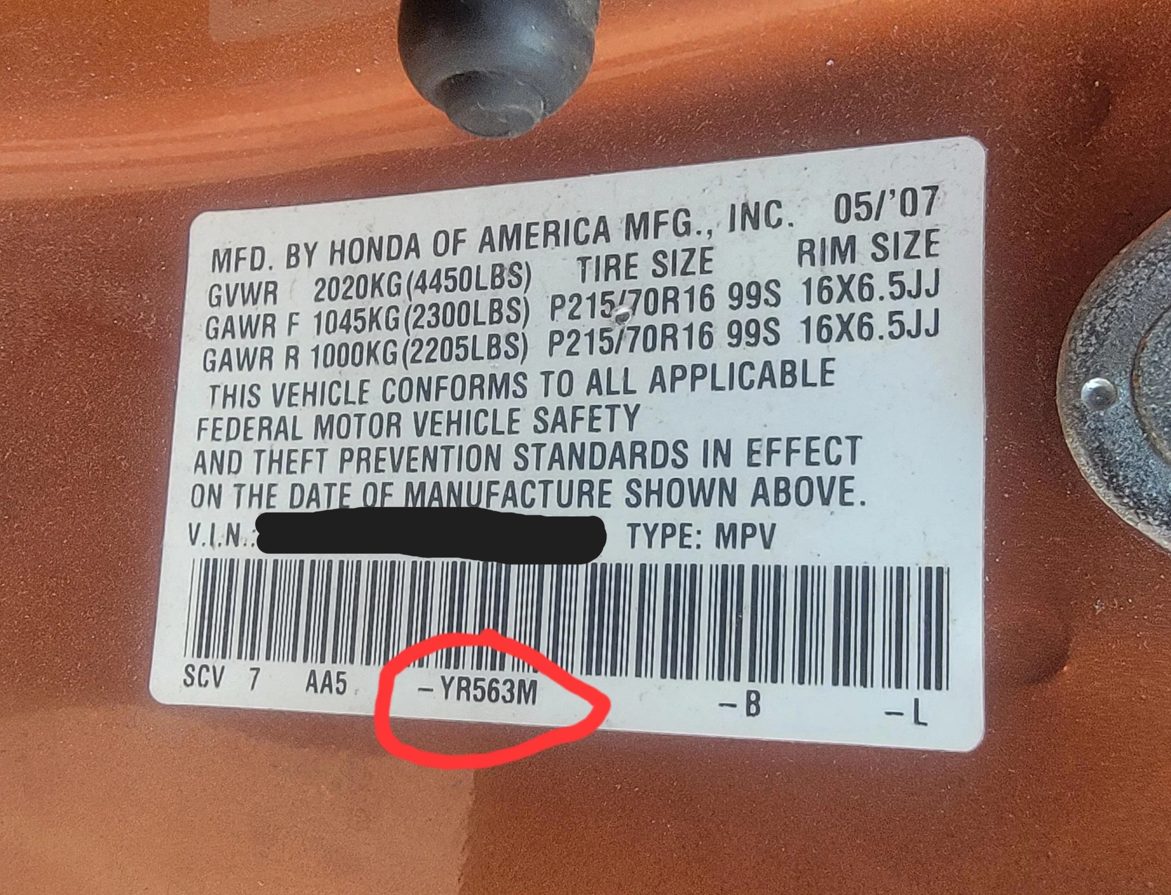 Honda certification label with the paint code YR563M circled on the bottom line under the barcode